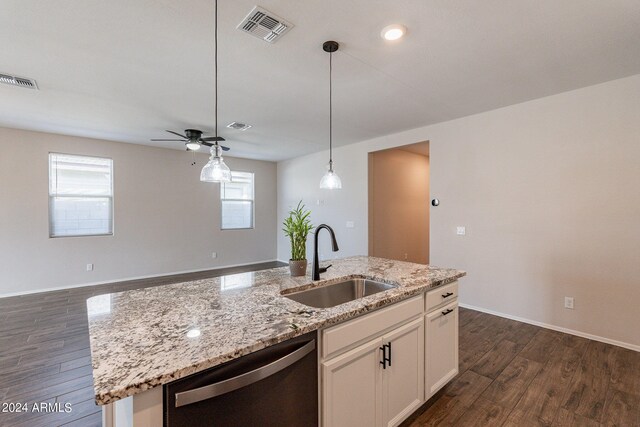 kitchen with white cabinets, sink, stainless steel dishwasher, a kitchen island with sink, and dark wood-type flooring