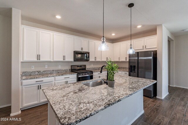 kitchen with appliances with stainless steel finishes, dark wood-type flooring, sink, and white cabinetry