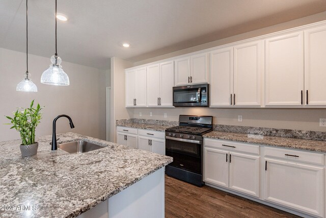 kitchen with sink, black range with gas cooktop, white cabinetry, dark hardwood / wood-style floors, and light stone countertops