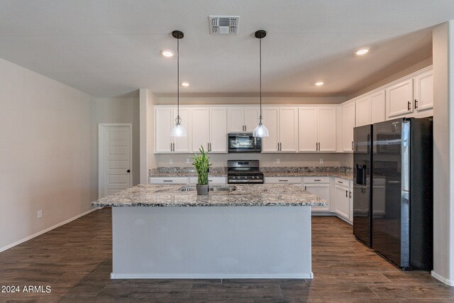 kitchen with an island with sink, white cabinetry, stainless steel appliances, and decorative light fixtures