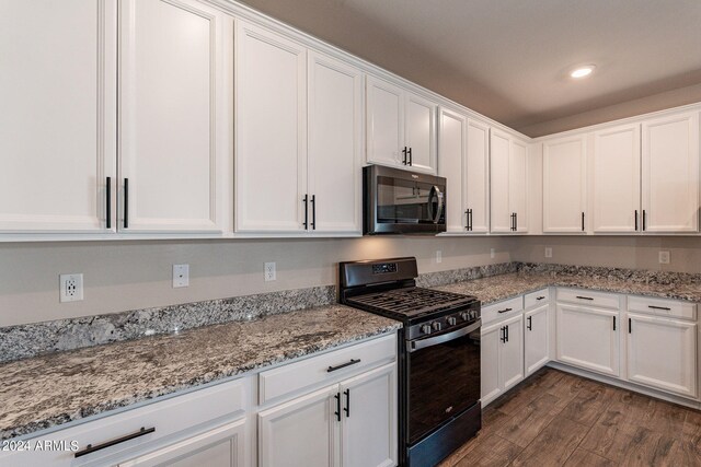 kitchen featuring light stone countertops, white cabinetry, black gas range oven, and dark wood-type flooring