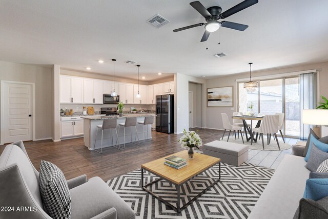 living room with ceiling fan and dark hardwood / wood-style floors