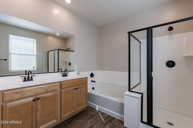 bathroom with vanity, shower with separate bathtub, and hardwood / wood-style floors