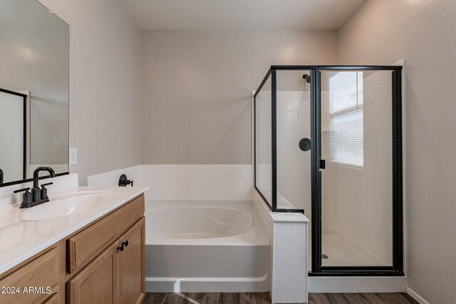 bathroom with vanity, separate shower and tub, and hardwood / wood-style flooring