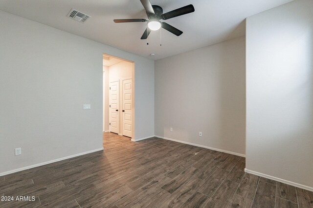 spare room with ceiling fan and dark hardwood / wood-style flooring