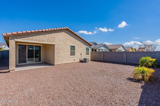 rear view of property with a patio and central air condition unit