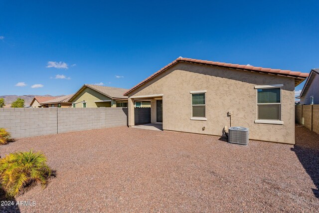 rear view of house with central air condition unit