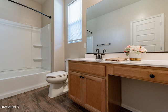 full bathroom with  shower combination, vanity, hardwood / wood-style floors, and toilet