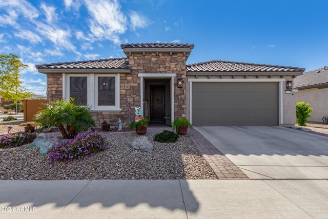 mediterranean / spanish house with a garage