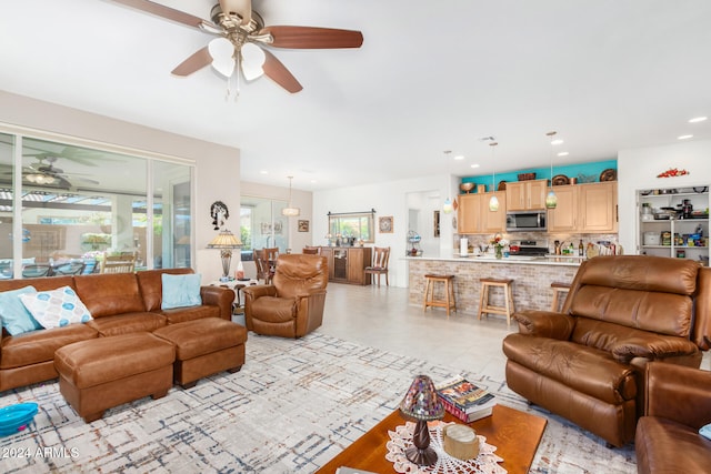 living room featuring ceiling fan and light tile patterned flooring