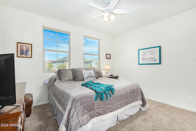 bedroom featuring ceiling fan and carpet