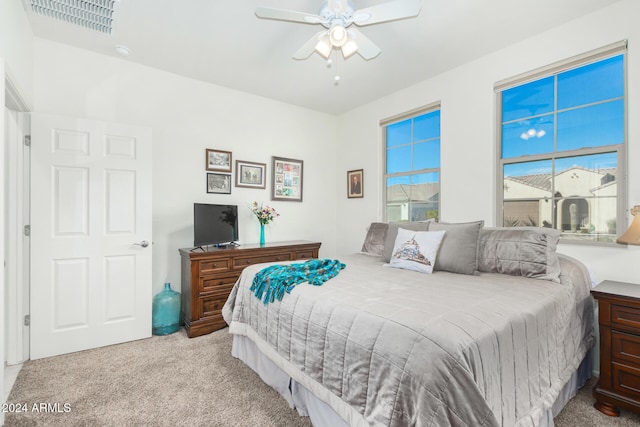 bedroom featuring light carpet and ceiling fan