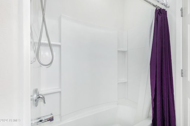 bathroom featuring shower / bath combo with shower curtain