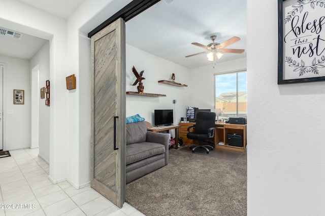 carpeted office space featuring ceiling fan