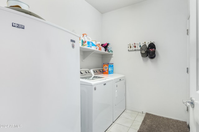 clothes washing area featuring separate washer and dryer and light tile patterned flooring