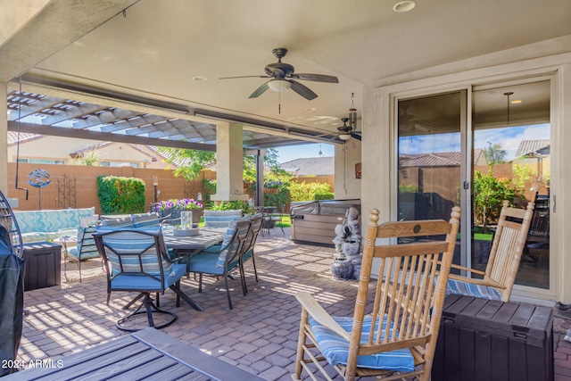 view of patio / terrace with a pergola, a hot tub, and ceiling fan