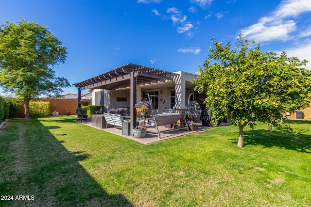 back of property with a pergola, a patio area, and a lawn