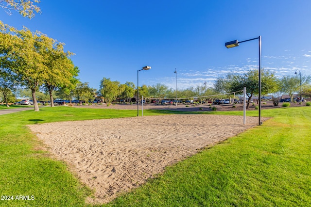 view of community featuring volleyball court and a lawn