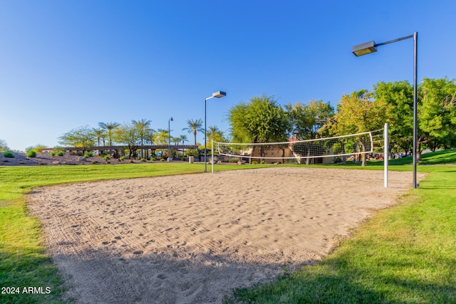 view of home's community with volleyball court and a yard