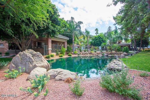 view of swimming pool with fence