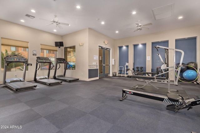 gym with recessed lighting, visible vents, ceiling fan, and a barn door