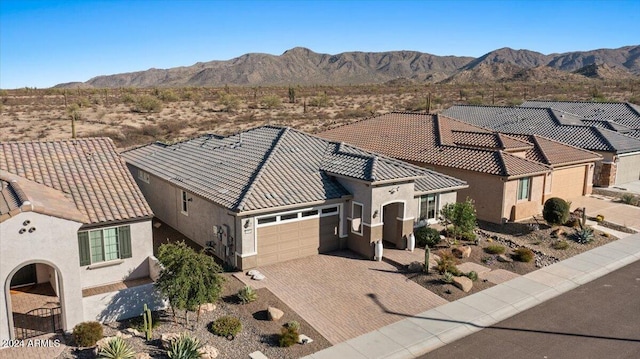 view of front of property featuring a garage and a mountain view