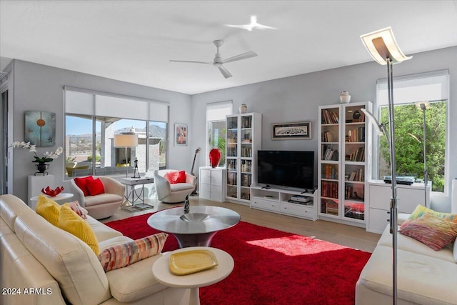 living room featuring light hardwood / wood-style floors, plenty of natural light, and ceiling fan