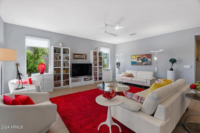 living room featuring ceiling fan and plenty of natural light