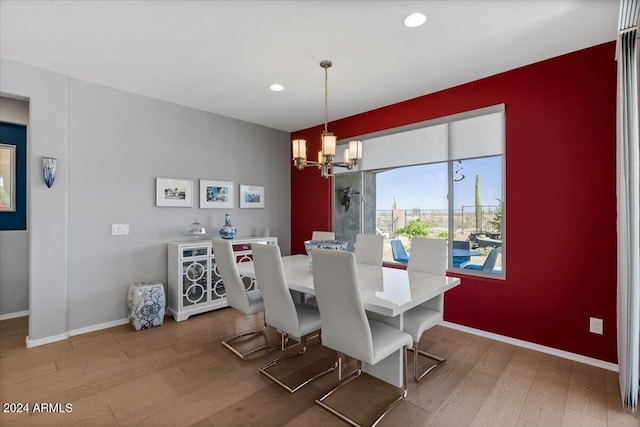 dining room featuring hardwood / wood-style flooring and a chandelier