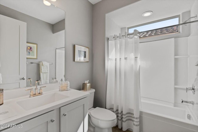 full bathroom featuring shower / bath combo with shower curtain, vanity, and toilet