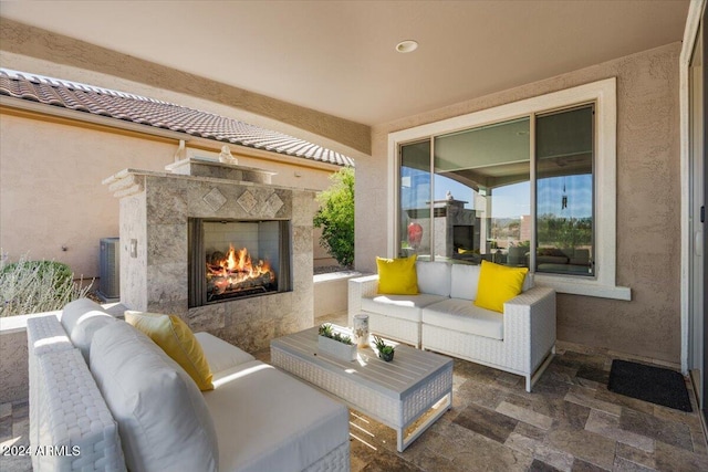 view of patio / terrace with cooling unit and an outdoor living space with a fireplace