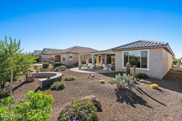 rear view of house featuring a patio