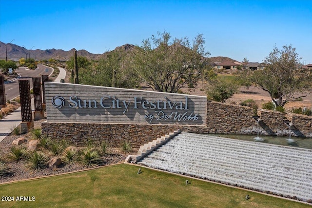 community sign with a mountain view