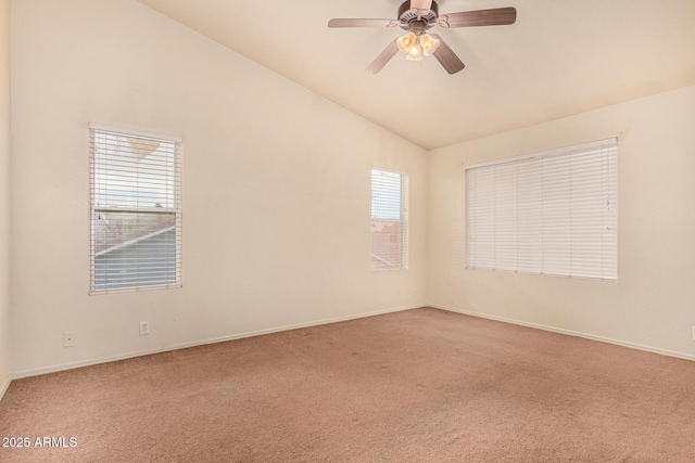 carpeted empty room featuring ceiling fan, a healthy amount of sunlight, and vaulted ceiling