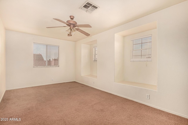 carpeted empty room featuring ceiling fan