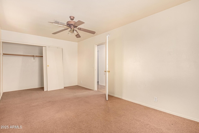 unfurnished bedroom with ceiling fan, a closet, and carpet floors