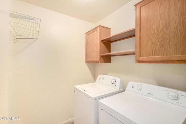 laundry room featuring cabinets and washing machine and clothes dryer