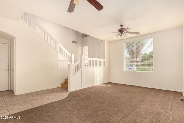 unfurnished living room featuring ceiling fan and light colored carpet