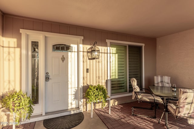 entrance to property featuring outdoor dining space