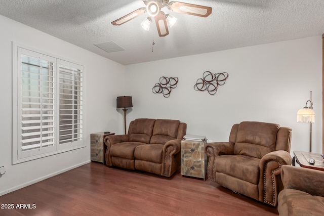 living room with ceiling fan, hardwood / wood-style floors, and a textured ceiling