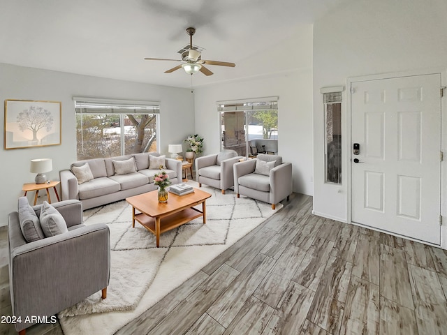 living room with light hardwood / wood-style flooring and ceiling fan