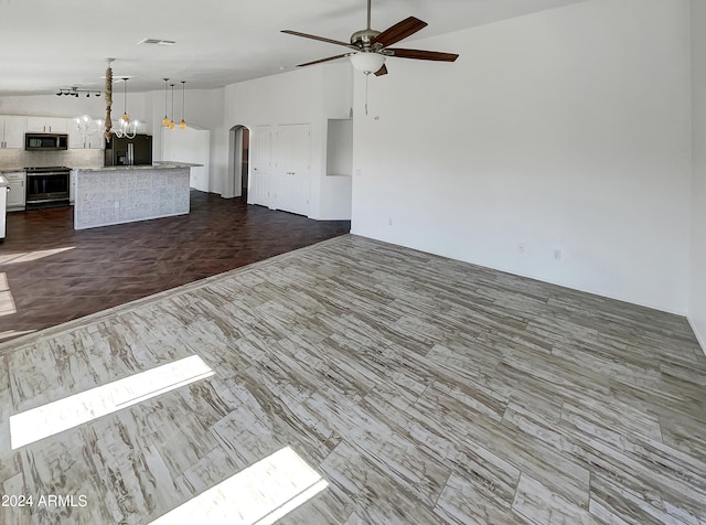 unfurnished living room featuring ceiling fan