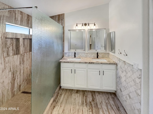 bathroom with a shower, vanity, and hardwood / wood-style flooring