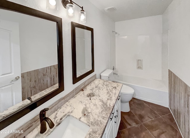 full bathroom featuring tile patterned flooring, vanity, toilet, and  shower combination