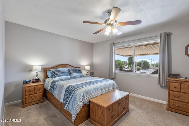 bedroom featuring a ceiling fan, light carpet, and baseboards