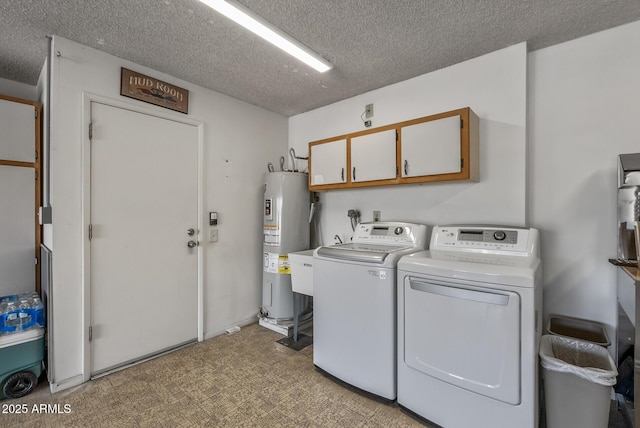 clothes washing area with cabinet space, a textured ceiling, washing machine and clothes dryer, and electric water heater