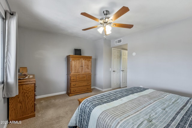 bedroom with light carpet, baseboards, visible vents, and ceiling fan