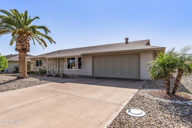 single story home with driveway and an attached garage