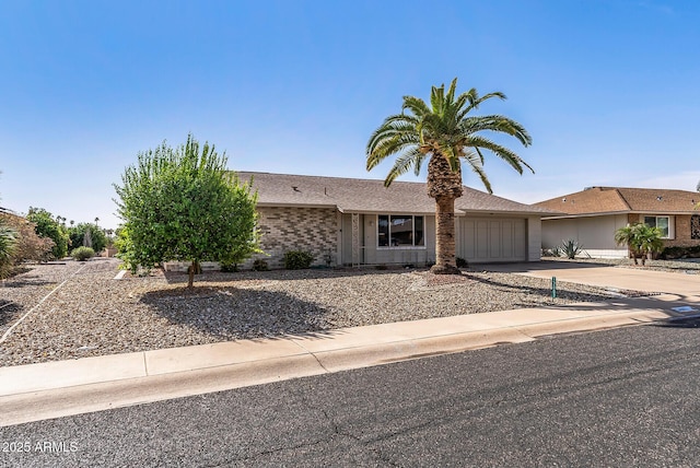 view of front of home featuring concrete driveway, brick siding, and an attached garage