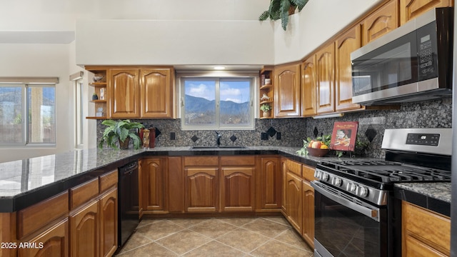 kitchen with appliances with stainless steel finishes, sink, backsplash, dark stone counters, and light tile patterned floors